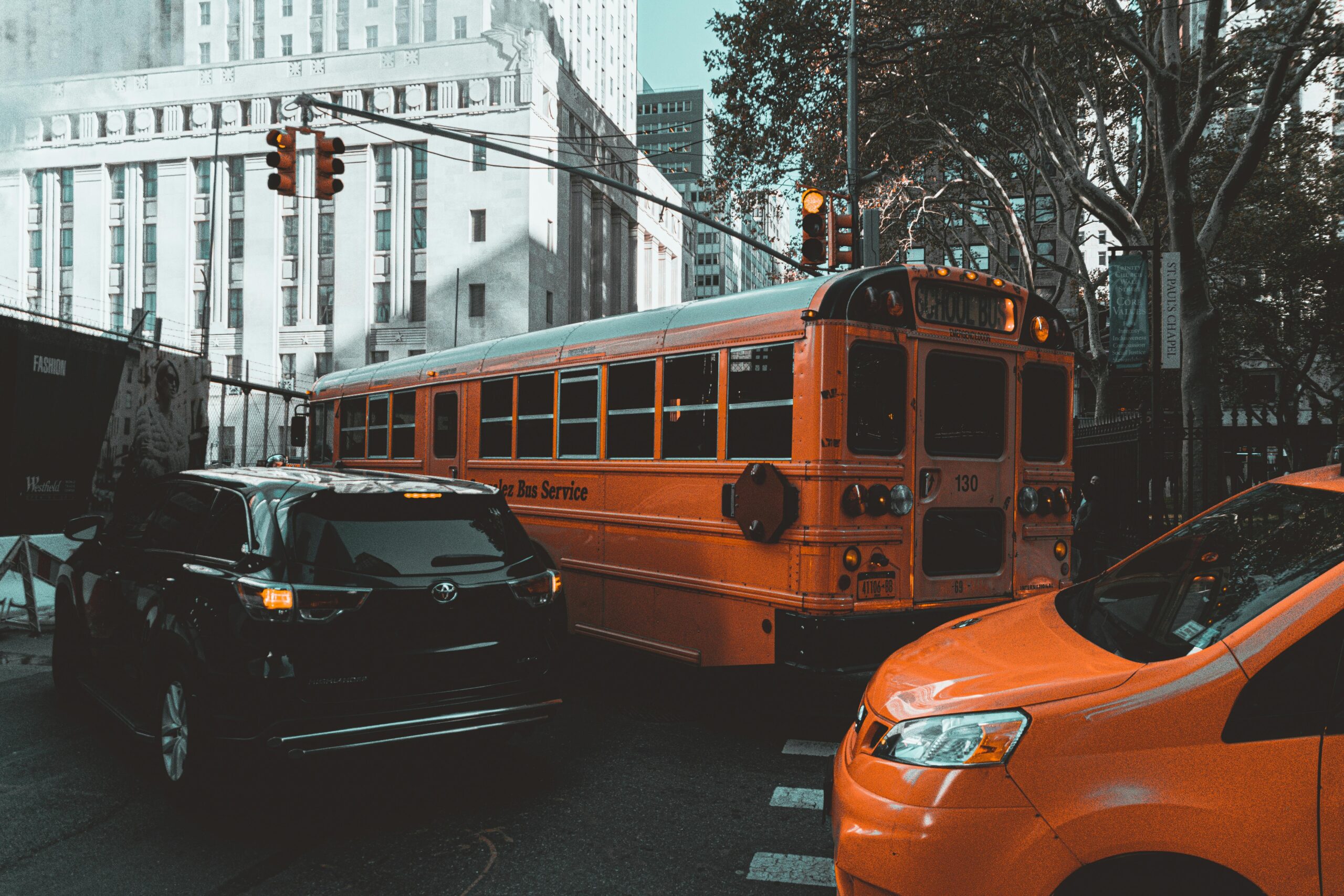 Busy New York City street with traffic including a classic yellow school bus.
