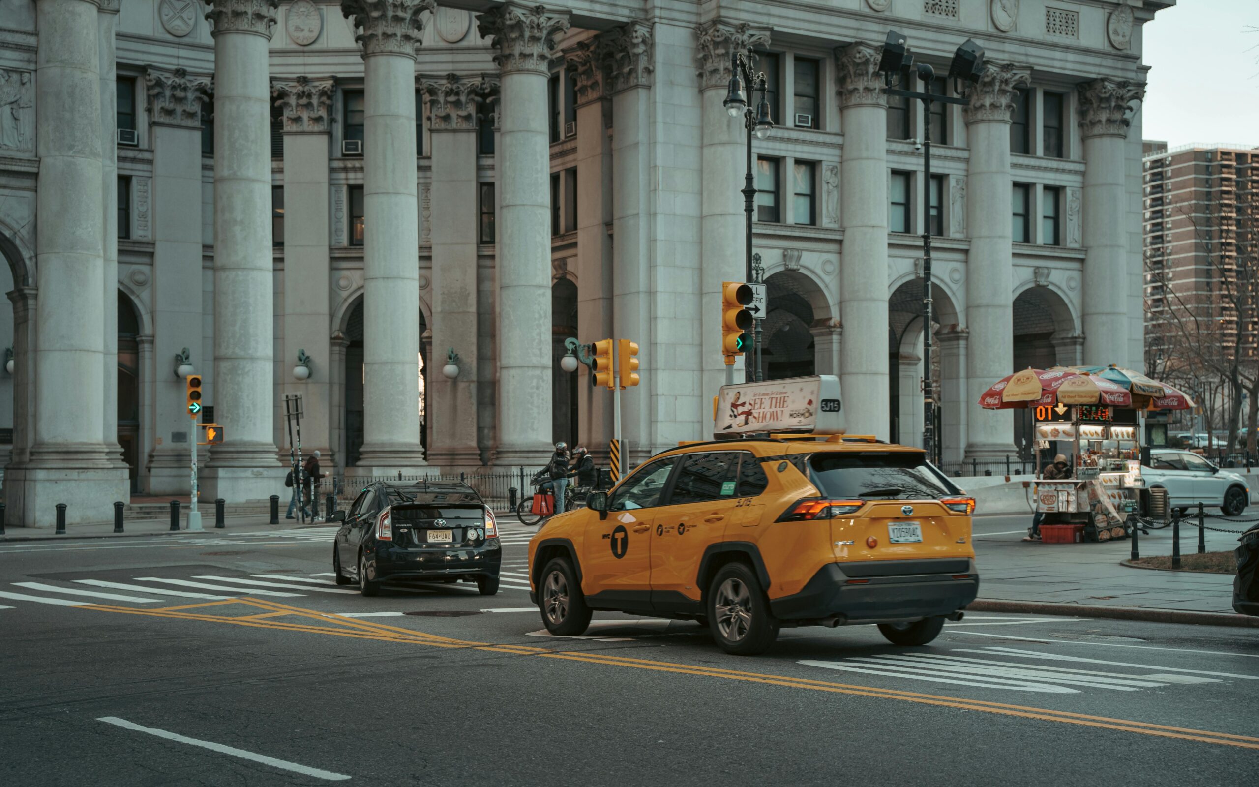 A typical New York City street with yellow taxi and historic architecture.